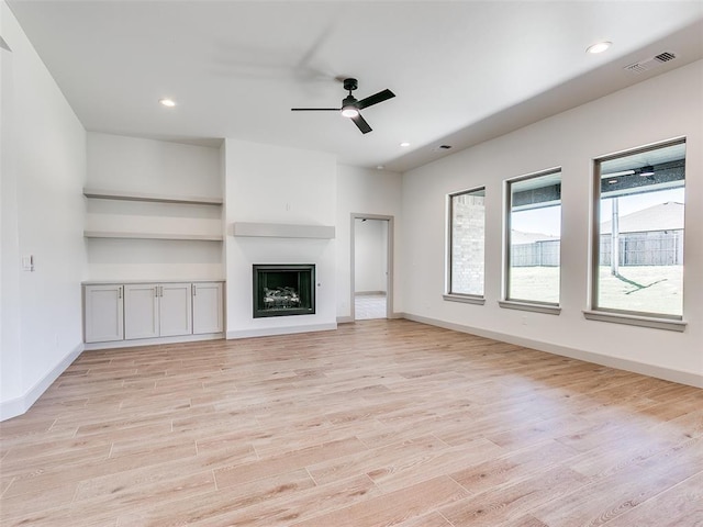 11508 NW 102nd St, Yukon, OK 73099 - unfurnished living room with light wood finished floors, a ceiling fan, a fireplace, baseboards, and recessed lighting