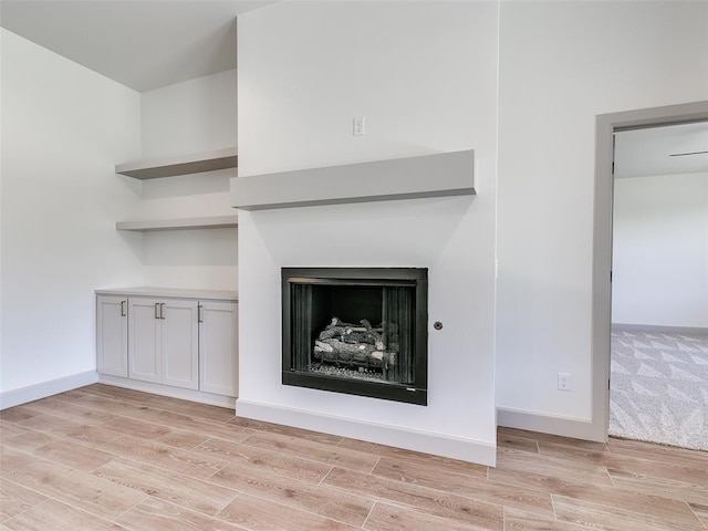 11508 NW 102nd St, Yukon, OK 73099 - detailed view of wood finished floors, baseboards, and a fireplace