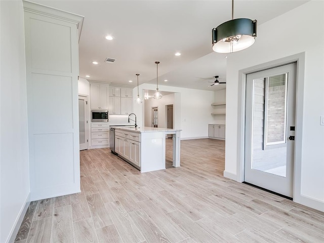 11508 NW 102nd St, Yukon, OK 73099 - kitchen featuring stainless steel appliances, light countertops, a breakfast bar area, white cabinets, and recessed lighting