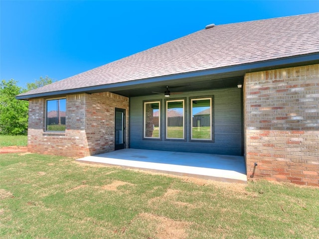 11508 NW 102nd St, Yukon, OK 73099 - rear view of house featuring brick siding, a shingled roof, a yard, and a patio