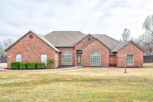 10904 Quail Run Rd, Oklahoma City, OK 73150 - traditional-style house with brick siding, a front lawn, and a shingled roof