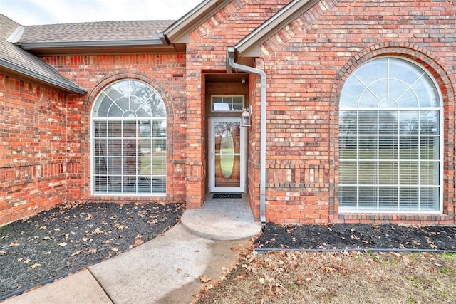10904 Quail Run Rd, Oklahoma City, OK 73150 - view of exterior entry with brick siding and roof with shingles
