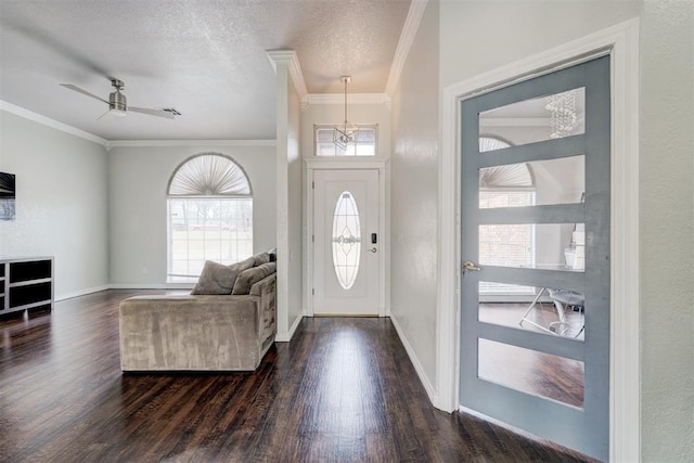 10904 Quail Run Rd, Oklahoma City, OK 73150 - foyer with ornamental molding, dark wood finished floors, a chandelier, baseboards, and a ceiling fan