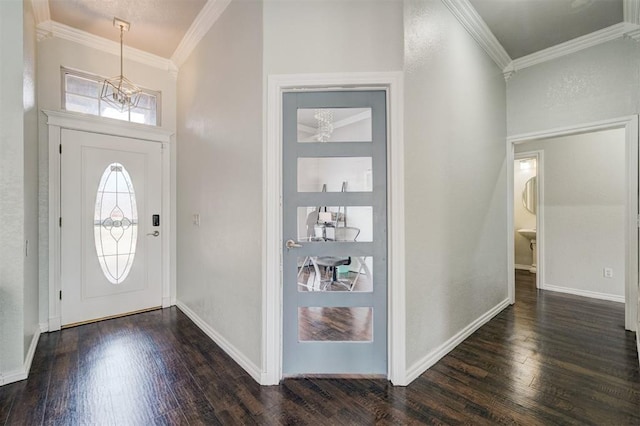 10904 Quail Run Rd, Oklahoma City, OK 73150 - entrance foyer with a chandelier, dark wood-style floors, crown molding, and baseboards