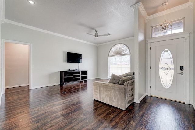 10904 Quail Run Rd, Oklahoma City, OK 73150 - foyer featuring dark wood-type flooring, a chandelier, ornamental molding, and baseboards