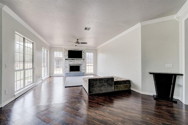 10904 Quail Run Rd, Oklahoma City, OK 73150 - living room with a brick fireplace, wood finished floors, a ceiling fan, ornamental molding, and a textured ceiling