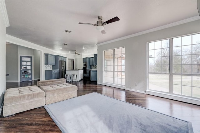 10904 Quail Run Rd, Oklahoma City, OK 73150 - living room with ornamental molding, a ceiling fan, dark wood-style floors, and baseboards