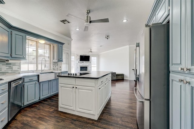 10904 Quail Run Rd, Oklahoma City, OK 73150 - kitchen with a ceiling fan, stainless steel appliances, open floor plan, crown molding, and a sink