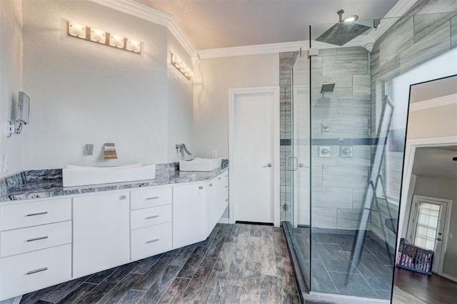 10904 Quail Run Rd, Oklahoma City, OK 73150 - full bathroom featuring crown molding, a shower stall, vanity, and wood finished floors