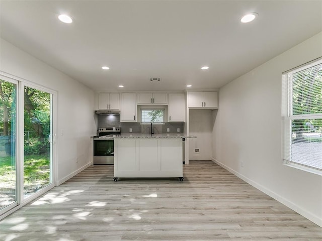 920 N Warren Ave, Oklahoma City, OK 73107 - kitchen featuring electric range, white cabinets, baseboards, recessed lighting, and light wood-type flooring