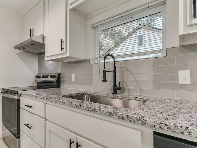 920 N Warren Ave, Oklahoma City, OK 73107 - kitchen featuring under cabinet range hood, stainless steel electric range oven, a sink, dishwasher, and tasteful backsplash