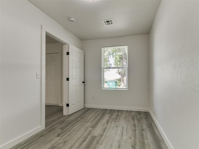 920 N Warren Ave, Oklahoma City, OK 73107 - spare room with light wood-style floors, baseboards, and a smoke detector