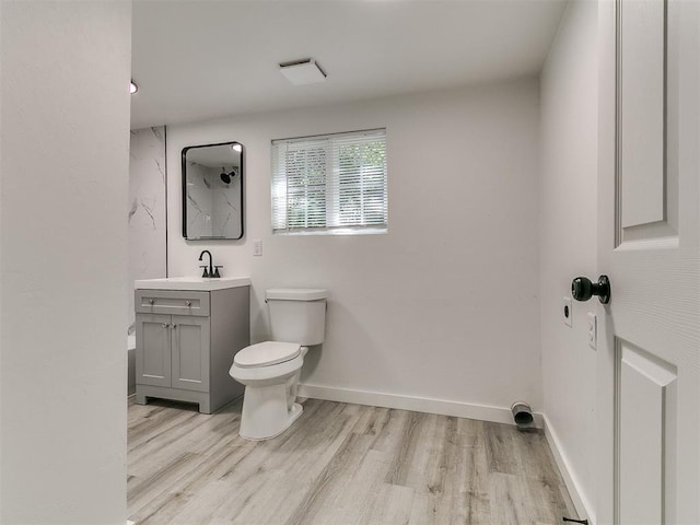 920 N Warren Ave, Oklahoma City, OK 73107 - full bathroom with vanity, wood finished floors, toilet, and a shower