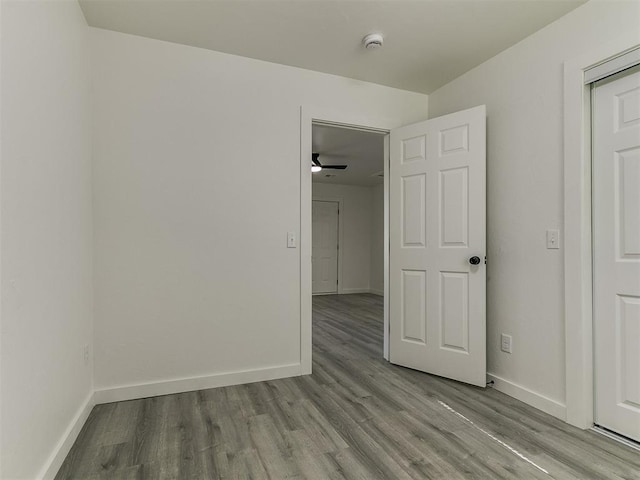 920 N Warren Ave, Oklahoma City, OK 73107 - unfurnished room with a smoke detector, wood finished floors, baseboards, and a ceiling fan