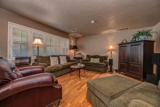 427 Foreman Ave, Norman, OK 73069 - living room with a textured ceiling and light wood-style flooring