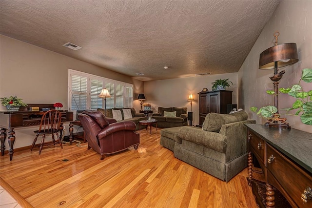 427 Foreman Ave, Norman, OK 73069 - living area with a textured ceiling and light wood finished floors
