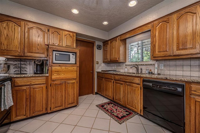 427 Foreman Ave, Norman, OK 73069 - kitchen featuring dishwasher, white microwave, brown cabinets, a sink, and backsplash