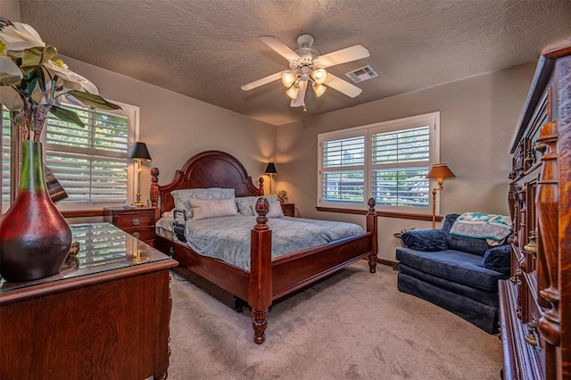 427 Foreman Ave, Norman, OK 73069 - bedroom featuring carpet floors, a textured ceiling, and a ceiling fan