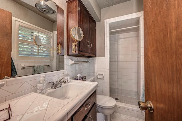 427 Foreman Ave, Norman, OK 73069 - bathroom with a shower stall, toilet, vanity, a textured ceiling, and tile patterned flooring