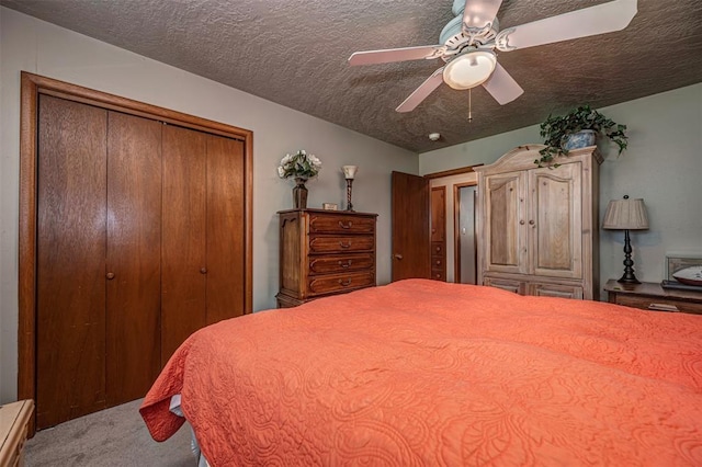 427 Foreman Ave, Norman, OK 73069 - carpeted bedroom with a textured ceiling, a closet, and a ceiling fan