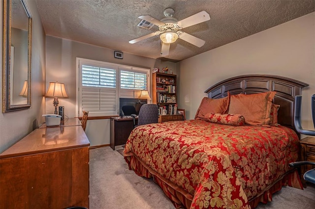 427 Foreman Ave, Norman, OK 73069 - bedroom with carpet flooring, a textured ceiling, an office area, and a ceiling fan