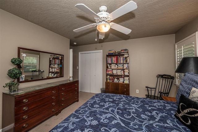 427 Foreman Ave, Norman, OK 73069 - bedroom with light carpet, a textured ceiling, and a ceiling fan