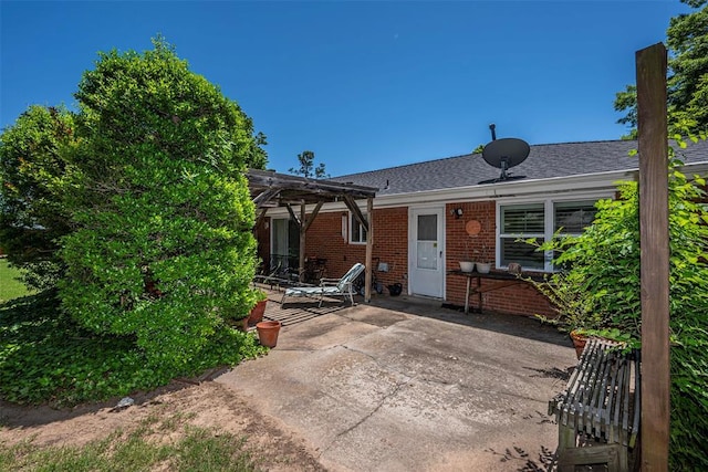 427 Foreman Ave, Norman, OK 73069 - back of house featuring a patio area, a pergola, brick siding, and roof with shingles