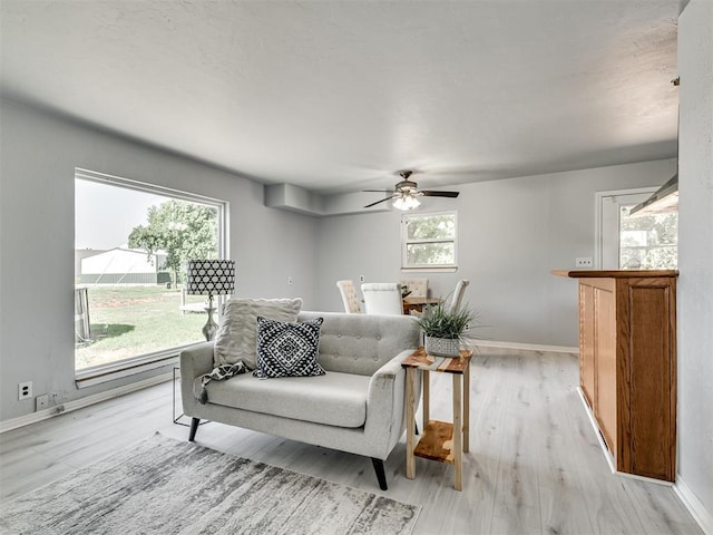 9290 N Hiwassee Rd, Jones, OK 73049 - living room with ceiling fan, baseboards, and light wood finished floors