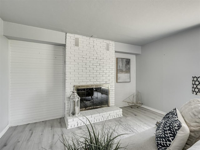 9290 N Hiwassee Rd, Jones, OK 73049 - living room featuring wood finished floors, baseboards, and a brick fireplace