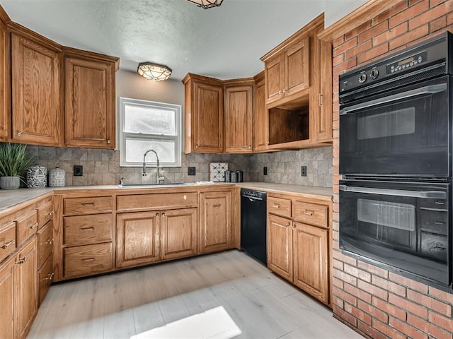9290 N Hiwassee Rd, Jones, OK 73049 - kitchen featuring a sink, black appliances, decorative backsplash, light countertops, and brown cabinetry