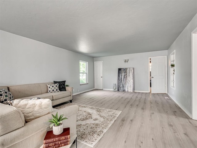 9290 N Hiwassee Rd, Jones, OK 73049 - living area featuring baseboards and light wood-style flooring