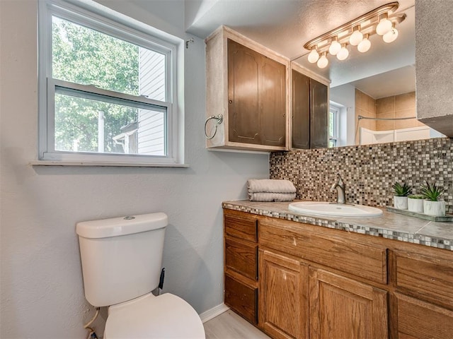 9290 N Hiwassee Rd, Jones, OK 73049 - full bathroom with decorative backsplash, vanity, toilet, baseboards, and a tile shower