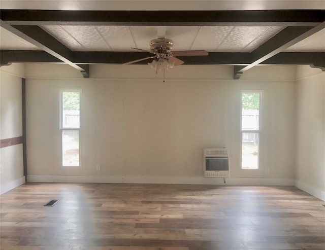 72 Lakeside Dr, Osage, OK 74054 - spare room featuring heating unit, beam ceiling, wood finished floors, and baseboards