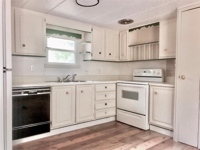 72 Lakeside Dr, Osage, OK 74054 - kitchen with electric range, black dishwasher, a sink, light countertops, and light wood finished floors