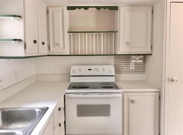 72 Lakeside Dr, Osage, OK 74054 - kitchen featuring white electric range, light countertops, a sink, and white cabinetry