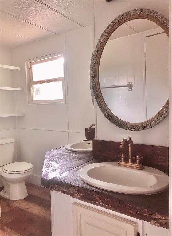 72 Lakeside Dr, Osage, OK 74054 - half bath featuring wood finished floors, toilet, and vanity