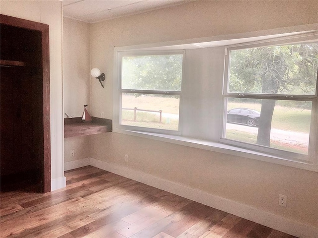 72 Lakeside Dr, Osage, OK 74054 - unfurnished bedroom with baseboards, wood finished floors, and multiple windows