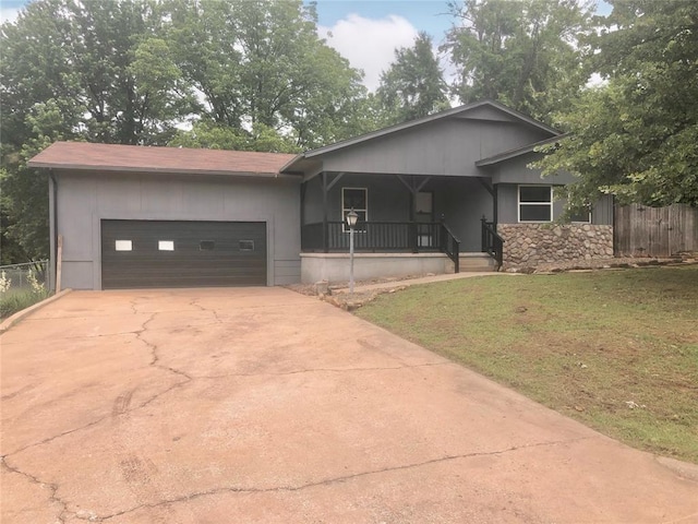 72 Lakeside Dr, Osage, OK 74054 - view of front facade with a porch, a garage, driveway, and stone siding