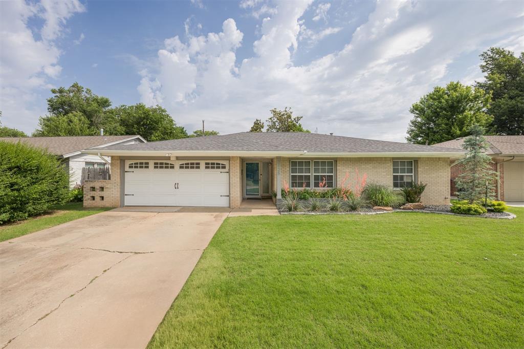 2125 Dublin Rd, Oklahoma City, OK 73120 - ranch-style home featuring brick siding, an attached garage, concrete driveway, and a front yard