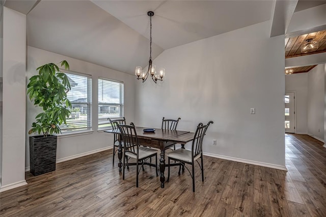 8516 Gibbs Dr, Oklahoma City, OK 73135 - dining room with lofted ceiling, dark wood-type flooring, baseboards, and a chandelier