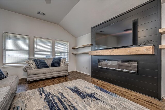 8516 Gibbs Dr, Oklahoma City, OK 73135 - living area with a fireplace, lofted ceiling, wood finished floors, and baseboards