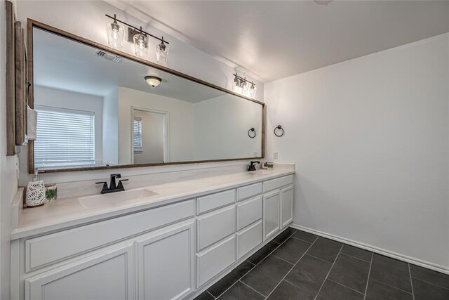8516 Gibbs Dr, Oklahoma City, OK 73135 - bathroom featuring double vanity, tile patterned flooring, and baseboards