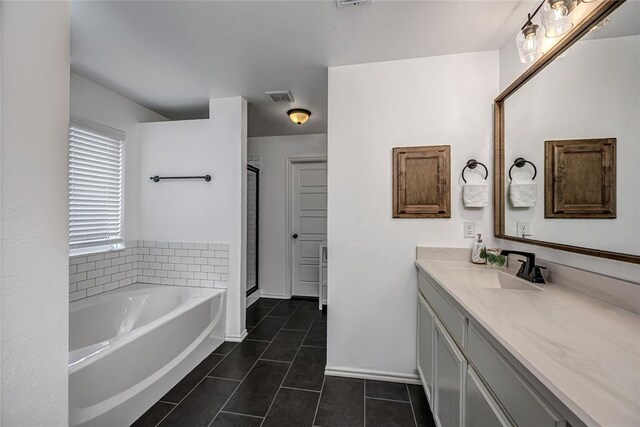 8516 Gibbs Dr, Oklahoma City, OK 73135 - full bath with tile patterned floors, vanity, a garden tub, a shower stall, and baseboards