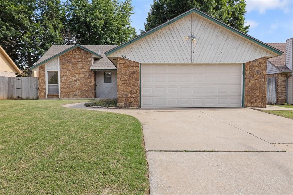 10532 Kristie Ln, Midwest City, OK 73130 - view of front of home with stone siding, concrete driveway, and roof with shingles