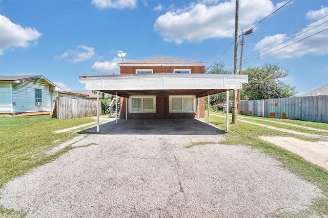 815 Hayes Ave, Clinton, OK 73601 - rear view of house featuring stairway, a carport, driveway, and brick siding