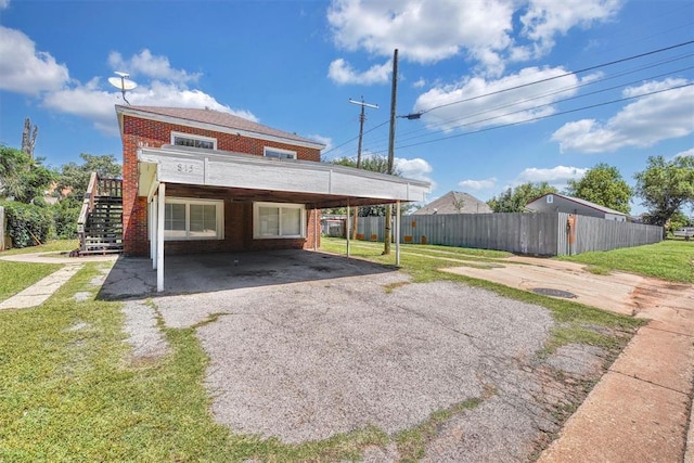 815 Hayes Ave, Clinton, OK 73601 - back of property with brick siding, stairway, and driveway