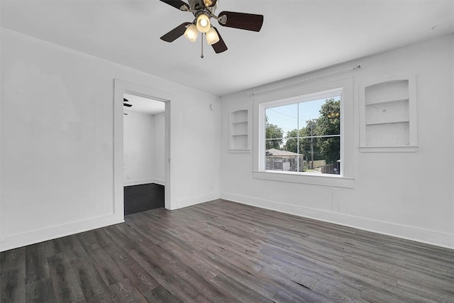 815 Hayes Ave, Clinton, OK 73601 - spare room featuring wood finished floors, a ceiling fan, baseboards, and built in shelves