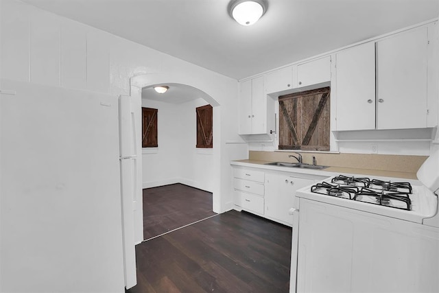 815 Hayes Ave, Clinton, OK 73601 - kitchen with a sink, white appliances, light countertops, arched walkways, and white cabinets