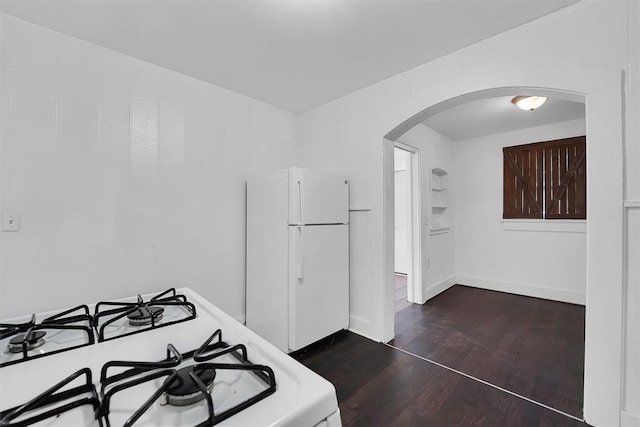 815 Hayes Ave, Clinton, OK 73601 - kitchen with white appliances, arched walkways, dark wood-style flooring, and baseboards