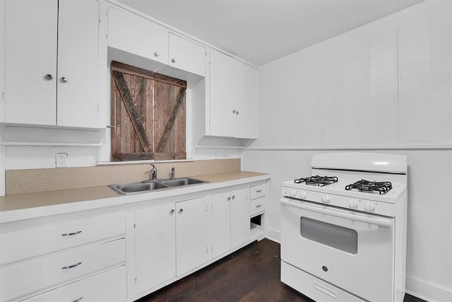 815 Hayes Ave, Clinton, OK 73601 - kitchen featuring white range with gas cooktop, a sink, light countertops, and white cabinetry